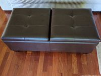 Closed ottoman showing tufted dark brown faux leather top