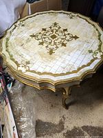 Top view of scalloped gilt and white table surface
