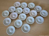 All 18 off-white plastic knobs displayed top view