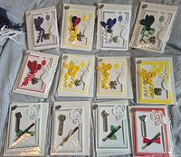 Front view of all 12 sealed balloon and incense greeting cards