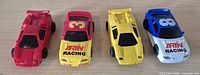 Front three-quarter view of all four slot cars