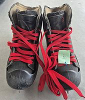 Front view showing Bauer Reactor 3000 goalie skates with red laces and scuffed toes