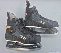 Side view of both skates showing branding, uppers, and blades