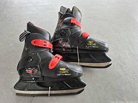 Side view of both skates showing overall design, decals, and blade condition