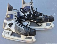 Left side view of both CCM 455 Tacks skates showing uppers, holders and blades