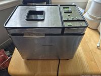 Front and side view of stainless steel Cuisinart convection bread maker on table