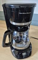 Full view of Hamilton Beach black programmable coffee maker with glass carafe