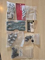 All items laid out showing grind plates, CCM kit, five bags of spacers