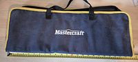 Front view of closed Mastercraft tool bag with tape for scale