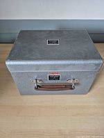 Front view showing leather handle and identification plate