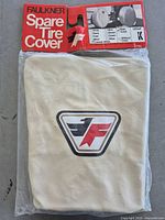 Front view of packaged Faulkner spare tire cover showing logo, color and branding