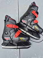 Side view of both skates showing graphics, buckles, and blades