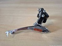 Full side view of Shimano front derailleur showing outer cage and overall condition