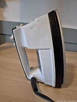 Left side profile of Proctor-Silex iron showing soleplate and handle