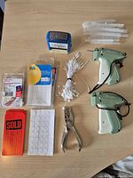 Full lot overview showing guns, labels, punch, stamp, fasteners