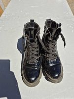 Top view of both boots showing laces, gloss finish and interior lining