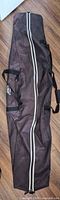 Full view of snowboard bag front showing length, stripe and handles