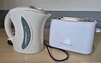 Proctor Silex kettle and Toastmaster toaster side by side, front view