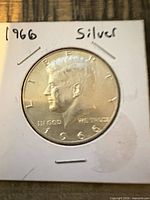 Obverse of 1966 Kennedy half dollar in flip