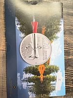 Front of presentation folder with mounted 2011 $20 silver coin