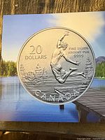 Front of packaging showing enlarged coin design and denomination