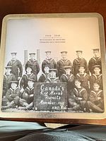 Front of tin tray showing sepia naval recruits image and caption