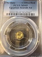 Front of PCGS slab showing certification label and coin obverse with scarab