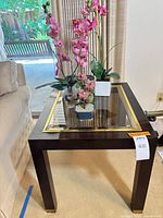 Overall view of accent table with three faux plants displayed on top