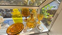 Group shot of all amber glass pieces in lot