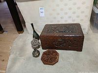 All five items grouped: carved box, vase, two burners, trivet