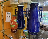 Front view showing pair of cobalt blue porcelain vases, red floral cloisonné vase and floral cloisonné brush pot