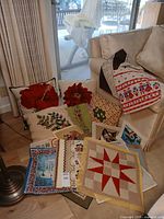 Group shot showing finished pillows and multiple unfinished canvases