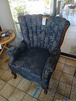 Full front view of blue wingback armchair
