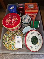 Bin containing assorted tins showing variety of shapes and graphics