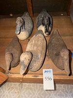 Five wooden duck decoys grouped