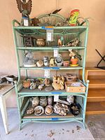 Front view of the rattan wicker etagere filled with decorative objects