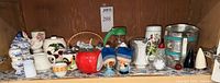 Full shelf view of assorted ceramic, glass and metal kitchenware