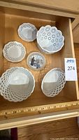 Seven porcelain pierced pieces arranged in drawer
