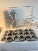 Overall lot with muffin pan, wire basket, plastic lid