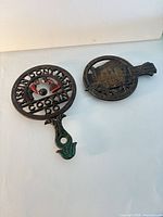 Both cast iron trivets side by side