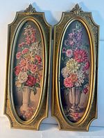 Front view of both framed floral oil paintings