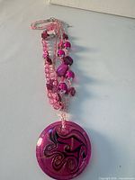 Full view of necklace with pendant and strands