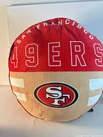 Front view of round San Francisco 49ers pillow showing full design and logo