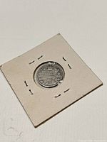 Coin in holder, reverse side visible