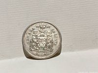 Reverse of 1960 Canadian 50-cent coin showing coat of arms