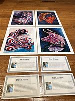 All four prints and four artist cards laid out