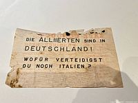 Front side of leaflet displaying German text and edge damage