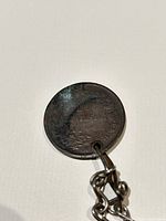 Reverse of coin showing 10 Centesimi denomination, drilled hole and patina