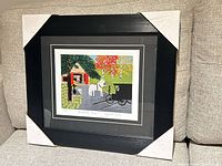 Front view of framed Maud Lewis print with corner protectors