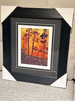 Framed print with corner protectors on couch
